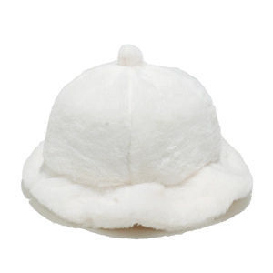 Close-up of soft white plush fabric and fluffy pom-pom detail on a warm winter bucket hat