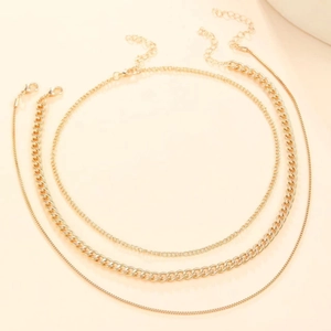 Detail of multi-layer golden chain necklace with lobster clasp and adjustable link
