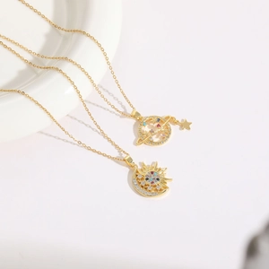 14K gold plated sun moon and planet necklaces with zircon stones on white porcelain