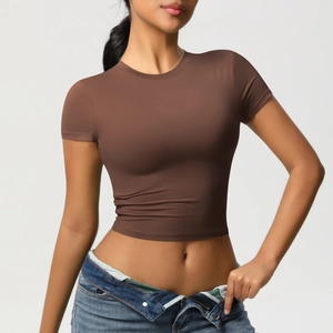 Detail view of a slim fit brown yoga crop top showing soft knit fabric and crew neck design