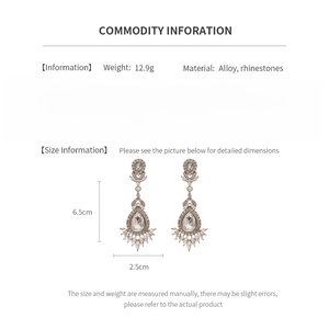 Detail view of sparkly flower drop earrings with rhinestones showing dimensions 6.5cm x 2.5cm