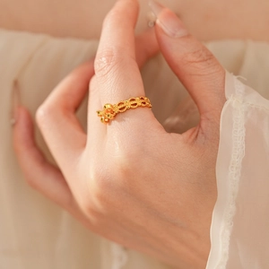 Macro detail of vintage gold flower ring featuring intricate lace hollow craftsmanship