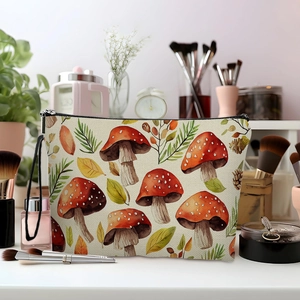 Canvas makeup bag with watercolor mushroom pattern and black zipper on vanity table