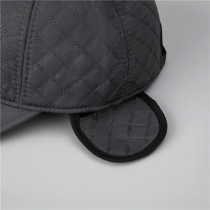 Close-up of diamond quilted windproof earflaps and stitching on winter baseball cap