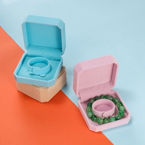 Detail of octagonal velvet jewelry boxes for bracelets in sky blue, pink and beige