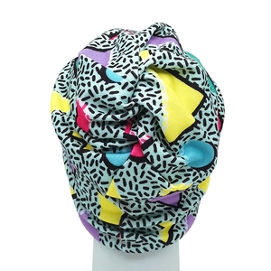 Retro geometric print beanie with yellow and blue patterns and a top knot design