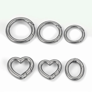 Polished silver stainless steel spring rings in round, heart, and oval shapes