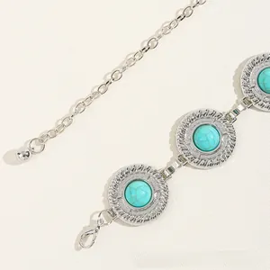 Detail of silver chain belt with turquoise stones and vintage gear-shaped settings