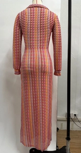 Detail of colorful striped crochet knit dress featuring geometric textures and long sleeves