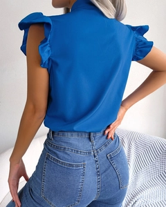 Detail view of the elegant blue ruffle sleeve shirt back with a stylish bow tie closure