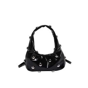Minimalist black shiny shoulder bag with silver rivet stud detailing and punk style design
