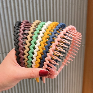 Close-up of colorful wave-shaped non-slip headbands stacked in various vibrant colors