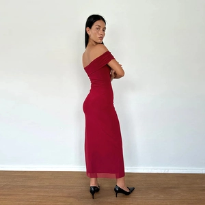 Detail view of red off-shoulder slim-fit midi dress showing side profile and fabric drape