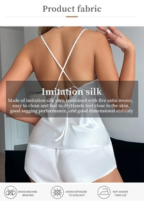 Detail of white ice silk camisole and shorts set showing back cross straps and satin texture