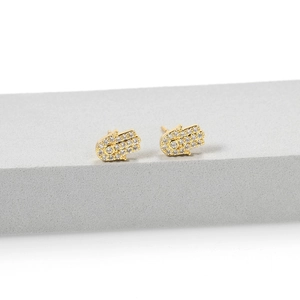 Macro shot of gold-plated Hamsa Hand earrings with micro-paved sparkling zircon stones