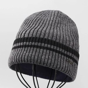 Close-up of gray ribbed knit beanie with black stripes and thick thermal lining