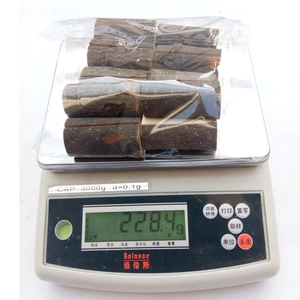 Close-up of 228g pack containing small natural wood logs for card holder base