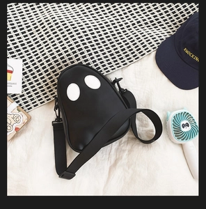 Detail of cute ghost-shaped PU leather crossbody bag with adjustable strap and metal hardware