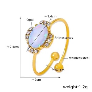 Detail of opal and rhinestone gold ring showing dimensions of 2.4cm height and 1.2g weight
