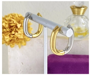 Close-up of U-shaped titanium earrings with gold and silver two-tone polished finish