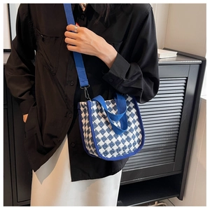 Detail of blue and white checkered canvas crossbody bag with wide shoulder strap
