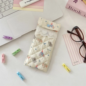 Detailed shot of a quilted cotton glasses case with elephant prints and lace heart decor