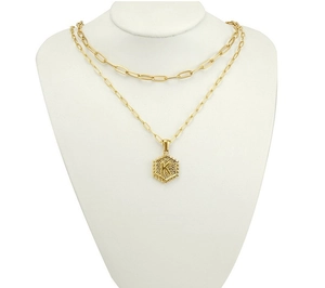 Detail of 18K gold double-layer necklace featuring a paperclip chain and K letter pendant