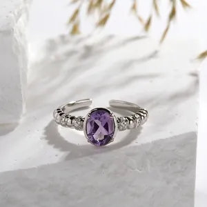 Detailed view of natural amethyst silver ring with ornate beaded band and zircon accents