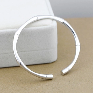Detailed macro view of a vintage silver-colored bamboo-joint open bangle bracelet