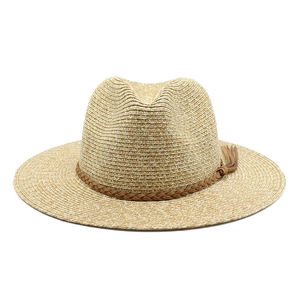 Detail of hand-woven straw Panama hat texture with brown leather band and tassels