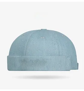 Detail of light blue denim miki hat featuring pink Music Club gothic embroidery
