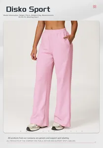 Detail of pink high-waisted wide-leg sweatpants showing fabric drape and side pockets
