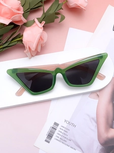 Macro detail of fashionable green cat-eye sunglasses on a modern geometric display stand