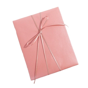 Elegant pearlescent pink gift box with matching ribbon on a clean white background