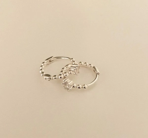 Detailed close-up of beaded 925 sterling silver hoop earrings with clear zirconia gemstone