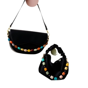 Set of black bags with colorful retro beads and gold hardware on white background