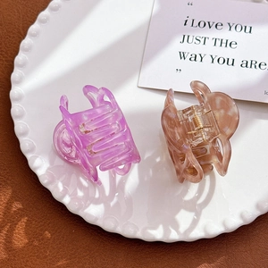 Set of two hollow camellia flower acetate hair claws in purple and brown transparent shades