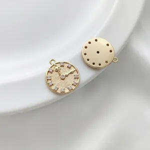 Macro shot of 14K gold-filled clock pendant with 12 zircon markers and a smooth back
