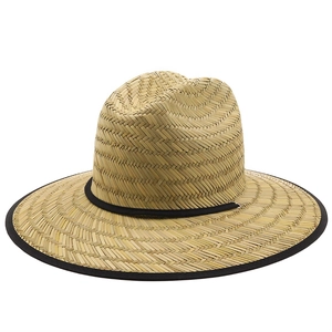Close-up of hand-woven straw texture and black fabric brim on the outdoor sun hat