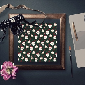 Macro detail of Christmas themed scrapbook paper with Santa patterns in a wooden frame