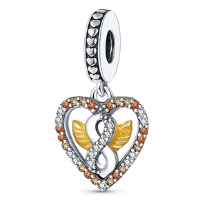 Macro view of silver heart charm featuring golden wings and infinity symbol detail