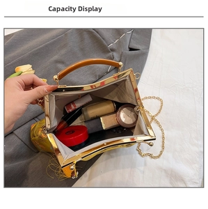 Capacity show of yellow embroidered handbag with amber handle and metal chain