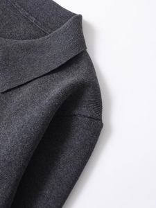 Detail shot of dark gray knit texture and high-quality shoulder stitching on casual coat