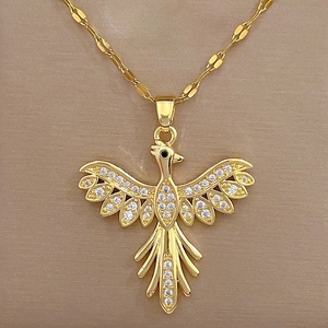 Close-up of golden phoenix pendant with sparkling rhinestones and black gem eyes