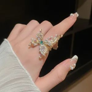 Vintage gold butterfly ring with pearls and crystals shown on a model's hand