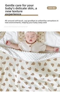 Close-up of baby blanket with soft brown bear prints and 3D sensory dot texture