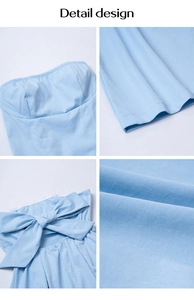 Detail design of light blue strapless dress featuring back bow and cotton fabric texture
