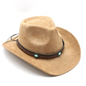 Detail of camel suede cowboy hat featuring turquoise gemstone and copper studded leather band