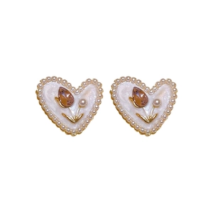 Minimalist heart stud earrings with white enamel, pearls, and pink tulip zirconia detail