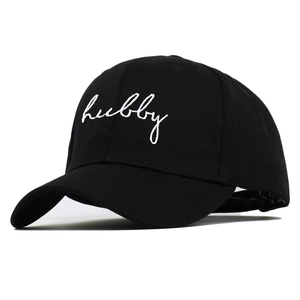 Detail of white Hubby embroidery on a black cotton baseball cap with curved brim